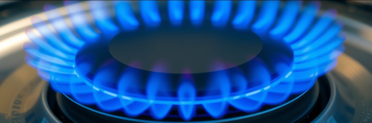 Close-up gas burner with blue flames for central heating service